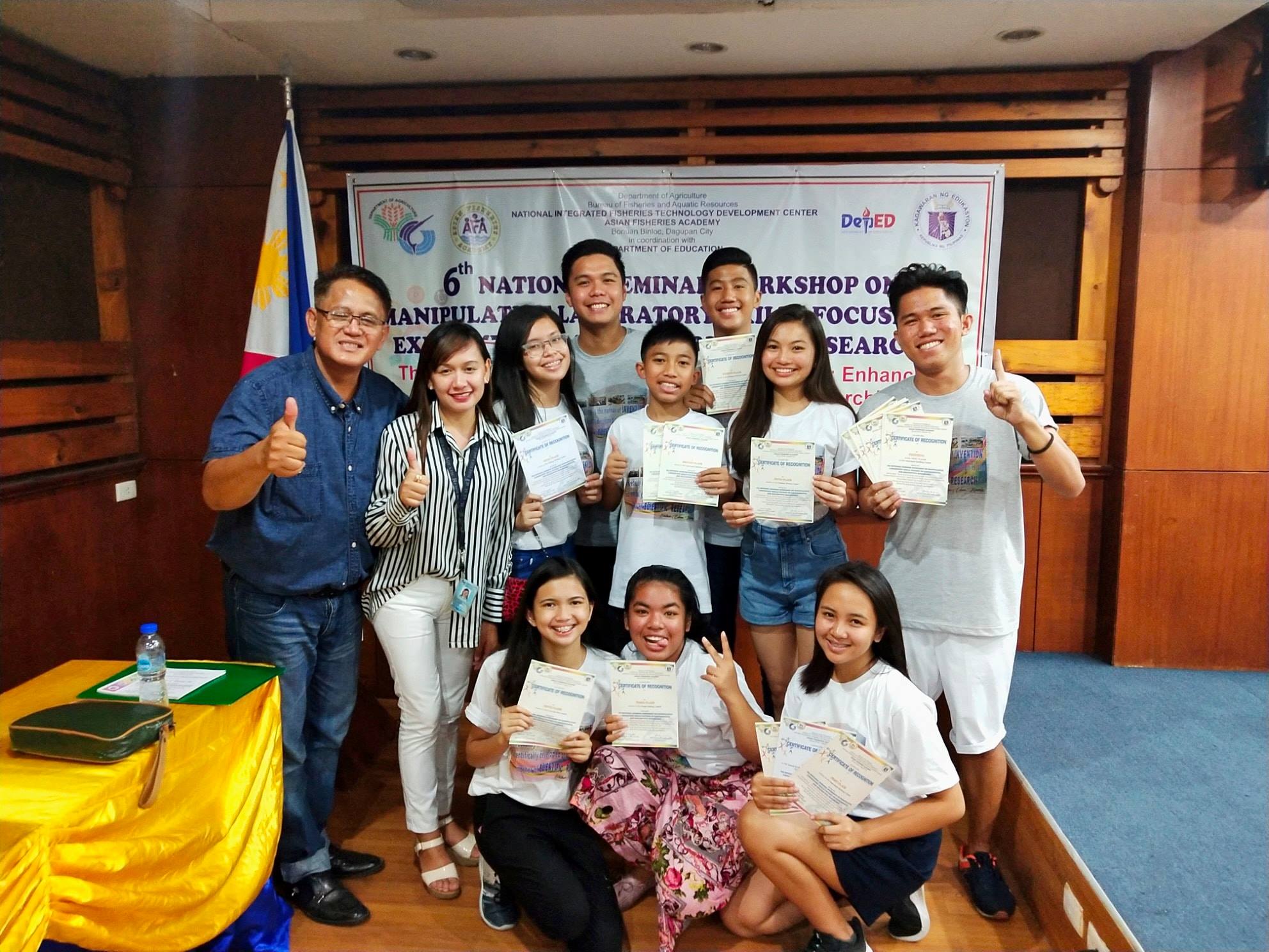 Bon competing or holding trophies from academic competitions